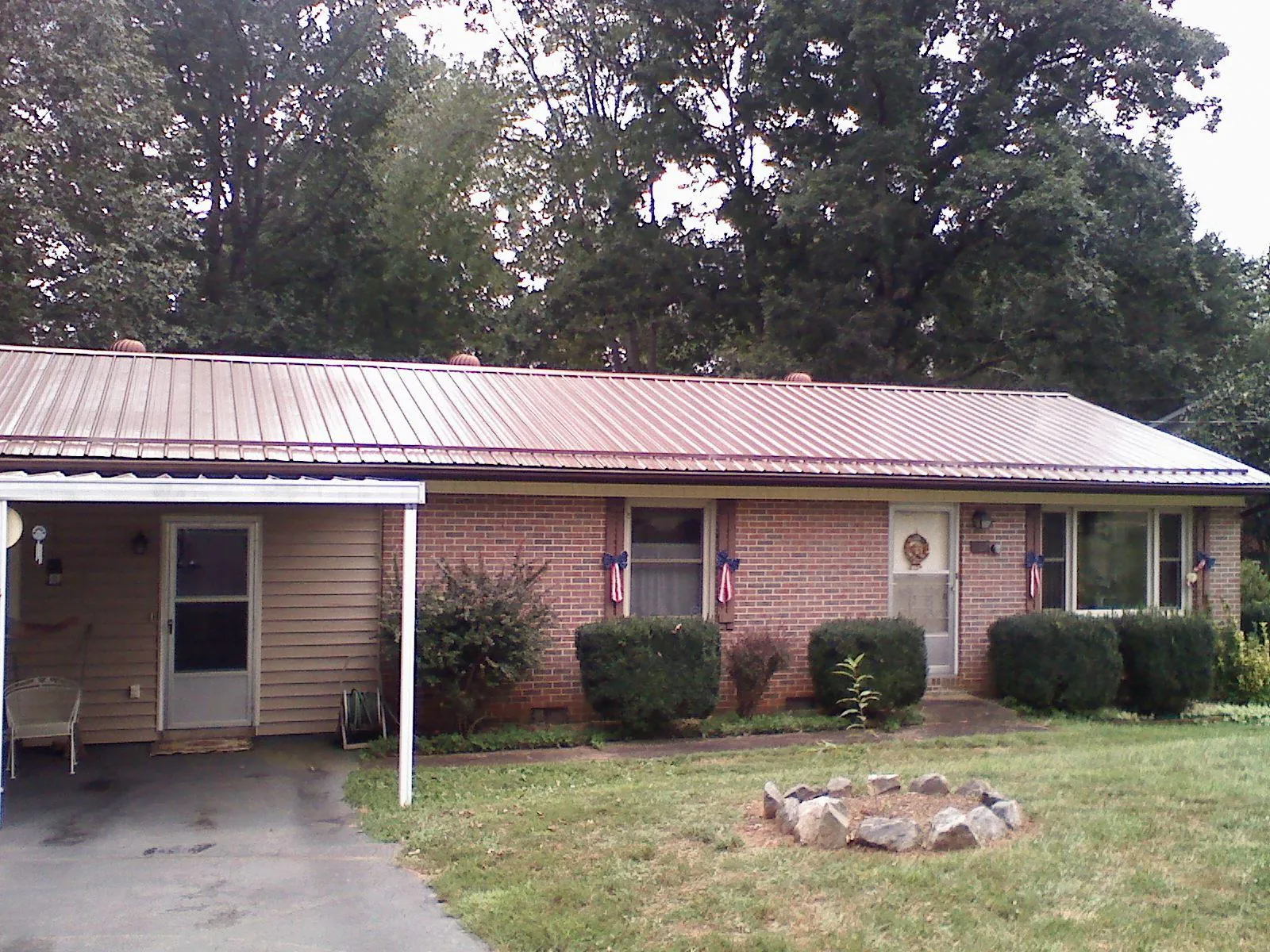 Bronze metal roof and carport on a brick ranch home — Roof Repair work by our crew in Missoula